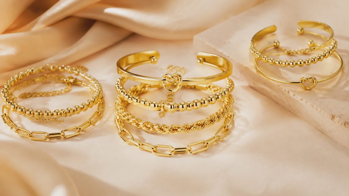 Full stackable gold bracelets set for women in lifestyle product arrangement